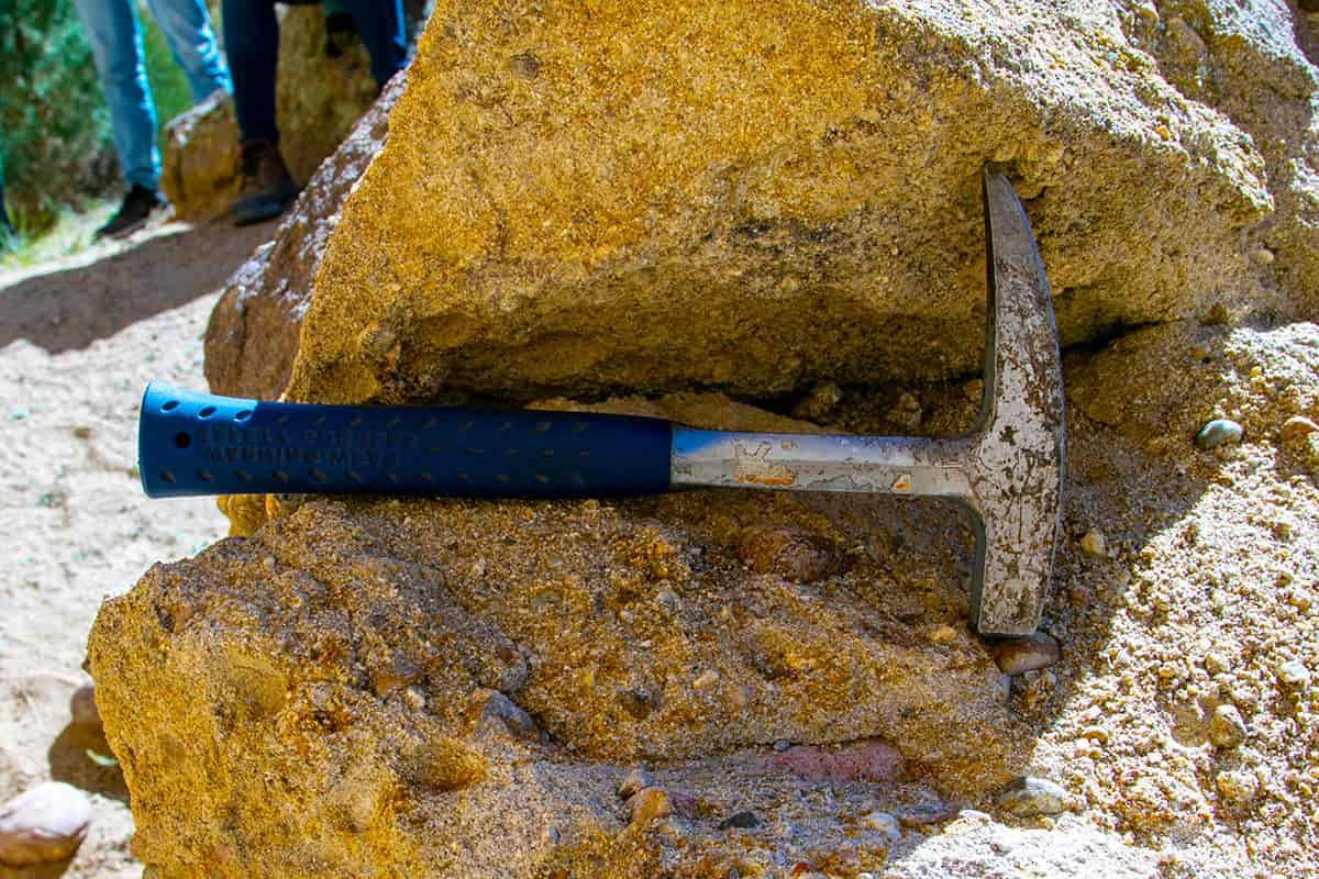 A pick axe sits on a boulder